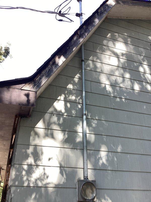 Conducted on-site evaluation of existing fused electrical panel in garage. Customer reported voltage drop issues with lights dimming when high-draw appliances such as air conditioning units operate, indicating inadequate circuit protection and outdated electrical distribution system. Inspected existing 8-12 circuit fuse panel and exterior service entrance components. Documented current electrical infrastructure including exterior meter base, service conduit, and panel location. Prepared comprehensive estimate for complete panel upgrade from obsolete fuse-type panel to modern circuit breaker panel with adequate amperage capacity to meet current electrical demands and code requirements.