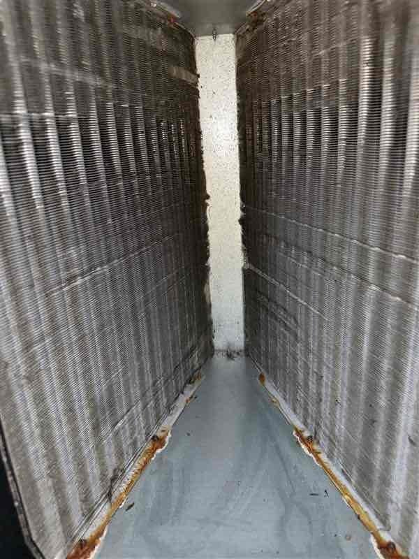 Performed Level 2 coil cleaning on 15-year-old Goodman air conditioning system with significant mold growth present in evaporator coil. Conducted thorough inspection of Carrier PAV furnace model, including detailed heat exchanger examination to assess integrity and safety. Documented ductwork conditions, noting rust staining at seams and confined space configuration of flexible metal ductwork installation. Recommended installation of air purification system (APCO or Blue Tube UV light system) to address ongoing indoor air quality concerns and prevent future microbial growth within the HVAC system.