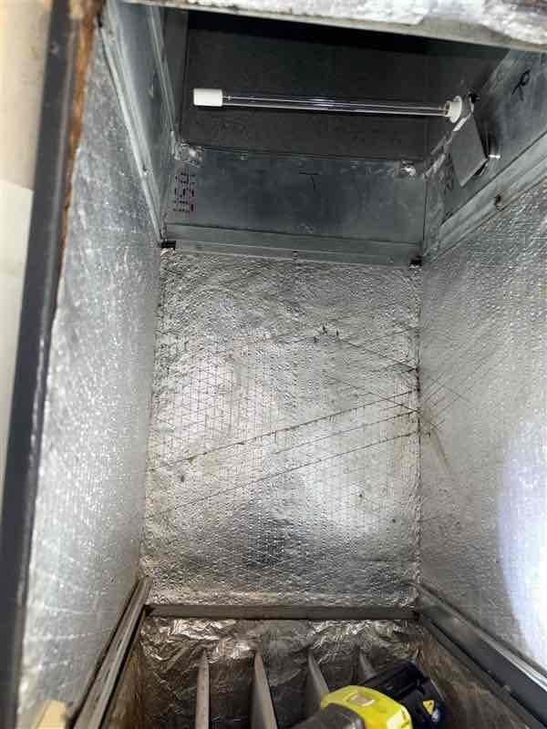 Performed Level 2 coil cleaning on 15-year-old Goodman air conditioning system with significant mold growth present in evaporator coil. Conducted thorough inspection of Carrier PAV furnace model, including detailed heat exchanger examination to assess integrity and safety. Documented ductwork conditions, noting rust staining at seams and confined space configuration of flexible metal ductwork installation. Recommended installation of air purification system (APCO or Blue Tube UV light system) to address ongoing indoor air quality concerns and prevent future microbial growth within the HVAC system.