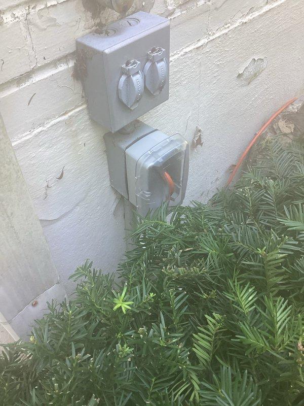 Completed exterior electrical outlet replacement and troubleshooting on weathered building exterior. Replaced deteriorated dual outlet fixture and associated weatherproof junction boxes mounted on exterior wall, installed new metallic gray weatherproof enclosures with proper conduit connections. Verified proper grounding and functionality of all replaced components.