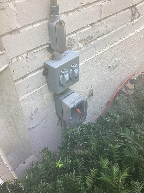 Completed exterior electrical outlet replacement and troubleshooting on weathered building exterior. Replaced deteriorated dual outlet fixture and associated weatherproof junction boxes mounted on exterior wall, installed new metallic gray weatherproof enclosures with proper conduit connections. Verified proper grounding and functionality of all replaced components.