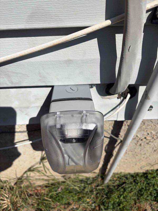 Completed electrical estimate for installation of new outdoor electrical outlet and ceiling fan. Assessed existing exterior electrical infrastructure including outdoor junction box mounted on deck railing and dual floodlight fixtures on vinyl siding. Evaluated routing requirements for 12-4 wire run from main panel to proposed exterior outlet location. Documented current outdoor lighting configuration and electrical access points to determine optimal installation pathway for new circuits. Verified adequate capacity for additional load and identified connection points for ceiling fan installation.