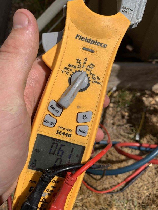 Performed comprehensive cooling system tune-up on 15-year-old outdoor AC unit. Conducted electrical diagnostics using clamp meter, recording voltage and amperage readings to verify proper system operation. Inspected and cleaned condenser coil fins, which showed good condition with minimal debris accumulation. Unit operating within normal parameters with no deficiencies noted at time of service.