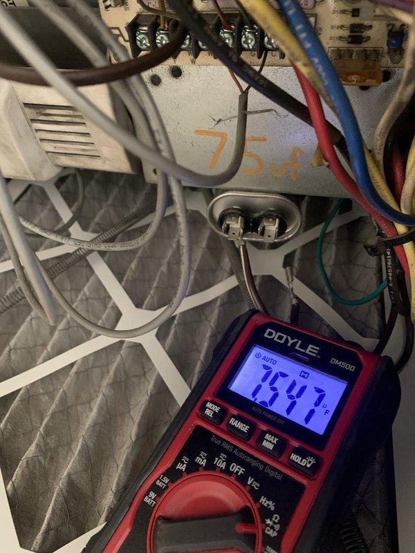 Performed comprehensive heating tune-up on a 10+ year old system located in utility closet. Conducted electrical diagnostics using multimeter to test blower motor assembly and capacitor, recording voltage readings of 75.4V to verify proper system operation. Inspected all electrical connections, wire bundles, and components within the unit to ensure safe and efficient heating system performance for the upcoming season.
