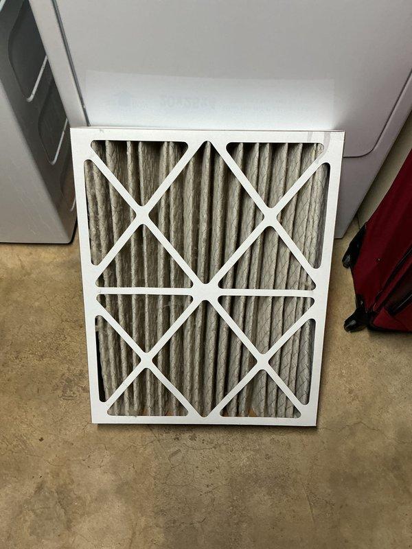 Completed preventative maintenance tune-up on a 4-year-old air conditioning system located in basement mechanical room. Performed comprehensive system inspection including electrical control board examination, verified all wire connections and relay operations, and documented control panel condition. Inspected and documented heavily soiled air filter showing significant dust and debris accumulation on pleated media, indicating proper filtration but requiring replacement for optimal airflow and system efficiency.
