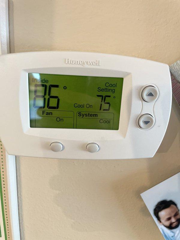 Responded to no cooling complaint on residential split system. Upon arrival, found thermostat calling for cooling with indoor temperature at 86°F and setpoint at 75°F, but system producing no cold air. Performed diagnostic evaluation of 10+ year old unit located in side yard. Inspected indoor air handler in basement mechanical room and outdoor condensing unit. System was running with airflow present but no refrigeration cycle occurring. Identified failed compressor contactor preventing outdoor unit from energizing. Replaced defective contactor, restored power to compressor and condenser fan motor. Verified proper system operation with temperature drop across evaporator coil and cold air delivery at registers. System returned to normal cooling operation.