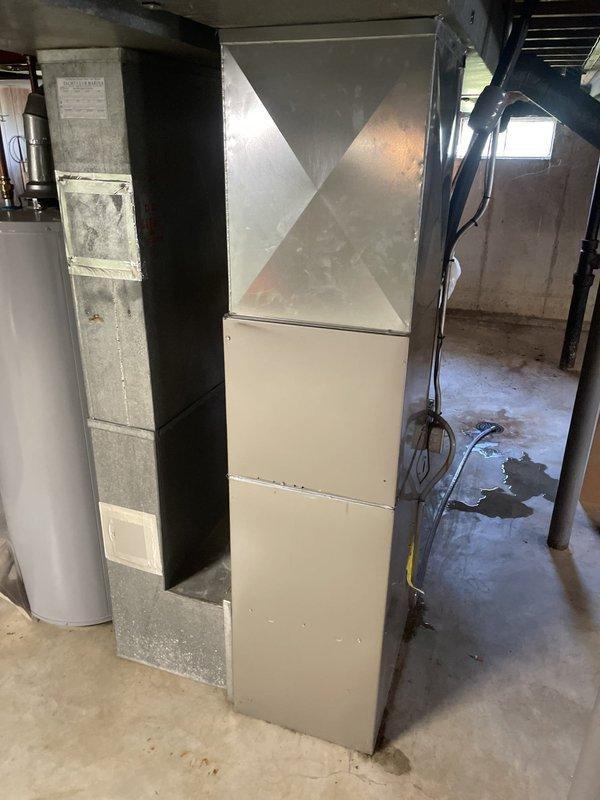 Responded to no cooling complaint on residential split system. Upon arrival, found thermostat calling for cooling with indoor temperature at 86°F and setpoint at 75°F, but system producing no cold air. Performed diagnostic evaluation of 10+ year old unit located in side yard. Inspected indoor air handler in basement mechanical room and outdoor condensing unit. System was running with airflow present but no refrigeration cycle occurring. Identified failed compressor contactor preventing outdoor unit from energizing. Replaced defective contactor, restored power to compressor and condenser fan motor. Verified proper system operation with temperature drop across evaporator coil and cold air delivery at registers. System returned to normal cooling operation.