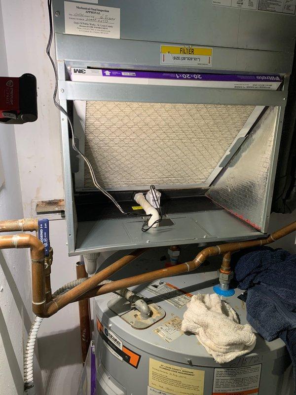 Responded to callback for water leakage from rooftop AC unit dripping onto hot water heater below. Inspected air handler drain system and P-trap assembly for blockages or improper drainage. Verified condensate drain line functionality, cleared any obstructions, and confirmed proper pitch and flow. Checked air handler filter (20x20x4) for restriction that could cause overflow, inspected drain pan for cracks or standing water, and ensured secondary drain safety switch operation. System tested and verified no active leakage present at time of service completion.