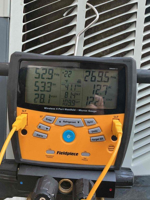 Responded to no-cool call on 22-year-old Trane system (Model CCBC48A4ACD0) experiencing repeated freeze-ups. Upon arrival, confirmed system was manufactured in 2004 and evaluated operational parameters using digital manifold gauges. Measured superheat at 59.2°F, indicating severely restricted refrigerant flow or low charge condition. Subcooling reading of 12.7°F and pressure readings of 52.9 PSI high-side and 28.95 PSI low-side confirmed inadequate refrigerant charge in the system. Given the age of the unit and the freeze-up symptoms, likely causes include refrigerant leak, restricted metering device, or compromised airflow across the evaporator coil. Documented system nameplate information and current operating conditions with photos for service records. Advised customer of findings and recommended options for repair versus replacement given the system's age exceeding typical equipment lifespan.