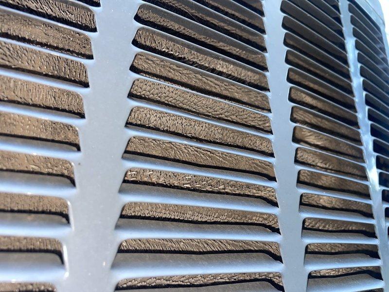 Responded to no cooling complaint on 13-year-old residential HVAC system. Upon arrival, contacted customer per request and proceeded with diagnostic evaluation. Found severely restricted airflow due to excessive dust and debris accumulation on return air grilles, significantly reducing system efficiency and cooling capacity. Cleaned all return vents and verified proper airflow restoration. Inspected furnace unit and ductwork in basement area, confirmed system operational with adequate cooling performance after addressing airflow obstruction.
