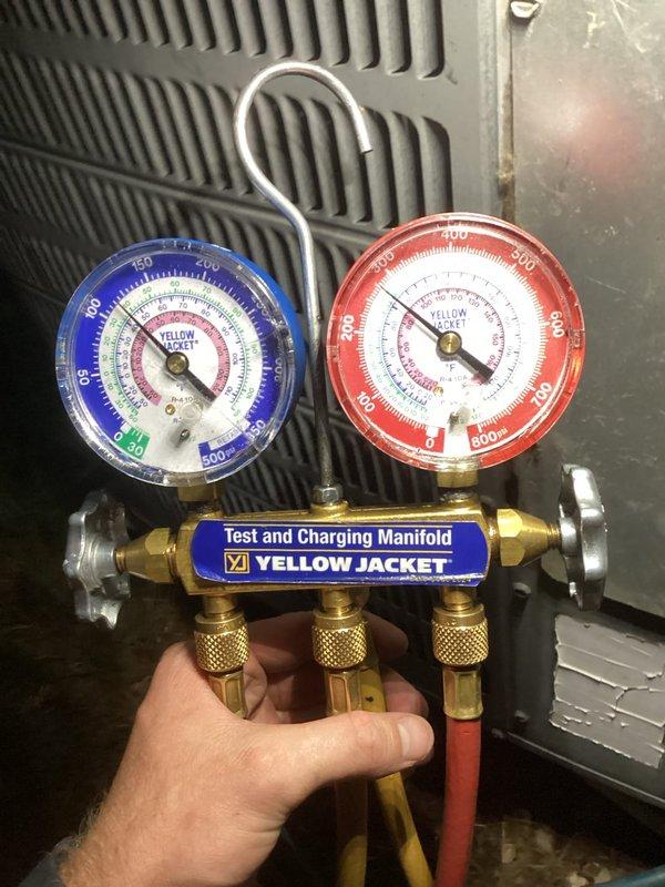 Responded to no cooling call on 16-year-old air conditioning system. Upon arrival, performed diagnostic testing using manifold gauge set to measure refrigerant pressures and system performance. Inspection revealed issues with the outdoor condensing unit. Checked refrigerant charge levels, superheat, and subcooling values at the evaporator coil. System assessment indicated the unit was not operating efficiently due to age-related component degradation. Photographed gauge readings and equipment condition for documentation purposes. Provided customer with repair options and recommendations for the aging system given its reduced reliability and efficiency after 16 years of service.