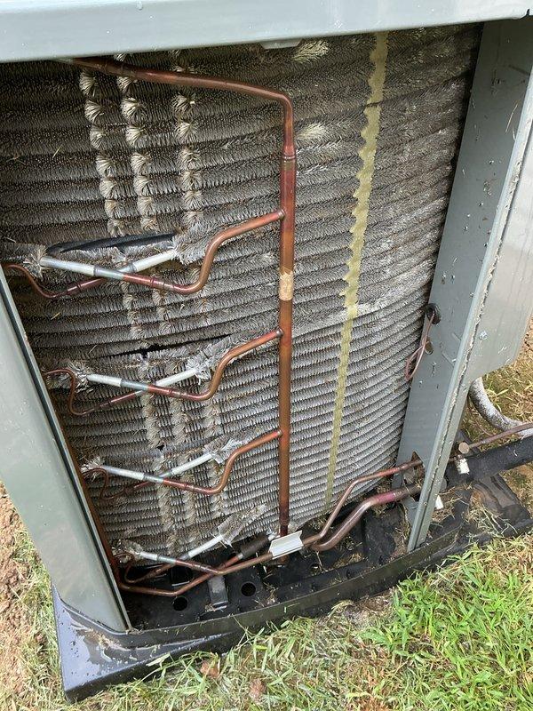 # HVAC Cooling System Tune-Up Completed

Performed comprehensive annual maintenance on a 6-year-old ground-level air conditioning unit located in the backyard. Accessed property using provided entry instructions and conducted full system inspection and tune-up procedures.

## Work Performed

Inspected outdoor condenser unit and found heavy accumulation of dust, dirt, and debris on condenser coils and finned surfaces. Removed back panel to access coil assembly for thorough cleaning. Cleaned condenser coils to restore proper heat transfer efficiency and airflow. Inspected refrigerant lines, copper tubing connections, and insulation for integrity and proper condition.

Proceeded to indoor air handler for filter service. Replaced existing air filter with new Purolator filter featuring pleated media and cardboard frame construction to ensure optimal airflow and filtration.

Completed standard tune-up checklist including:
- Visual inspection of all accessible components
- Verification of ref