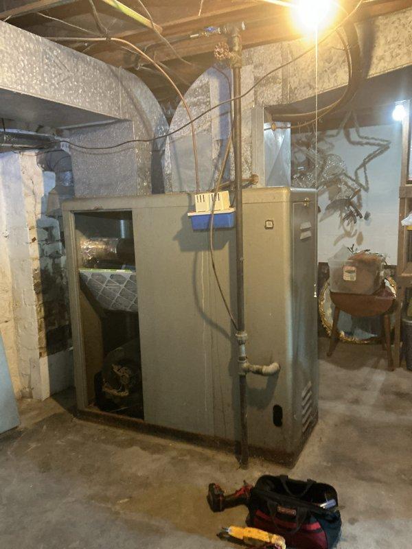 # HVAC Service - No Cool 10+

Responded to service call for outdoor unit making unusual noises during shutdown cycle on 10+ year old system. Upon arrival, performed comprehensive system inspection including indoor air handler and outdoor condensing unit. Inspected blower assembly and filter housing, noting accumulated dust and debris on blower wheel and housing surfaces. Checked indoor air handler components for proper operation and airflow restrictions. Evaluated outdoor unit for mechanical issues related to reported shutdown noise. Documented system conditions with photos showing blower assembly with visible dirt accumulation on squirrel-cage fan and filter housing, as well as overall basement installation configuration with ductwork connections. System evaluated for age-related wear and proper operation of all major components.