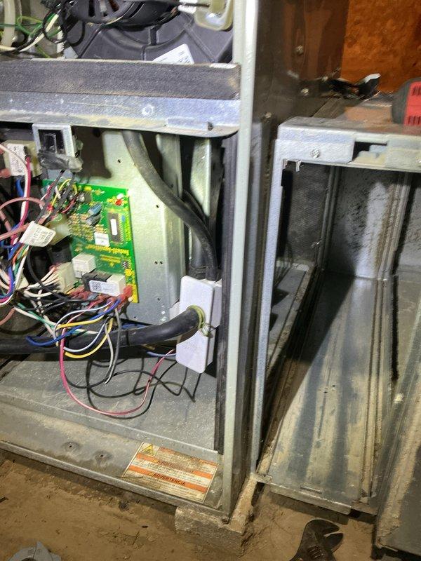 Responded to no-cool call with system freezing up. Upon arrival, accessed air handler in utility area and inspected blower motor assembly and control board with unit off as previously advised. Evaluated over 10-year-old system showing typical dust and debris accumulation on blower wheel and housing. Examined electrical connections, control board wiring, and motor components to diagnose freeze-up condition. Documented internal components including circuit board, blower assembly, and motor specifications for assessment of airflow restriction causing coil to ice. Recommended cleaning and further evaluation of airflow issues contributing to system freeze-up.