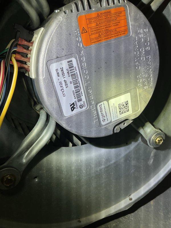Responded to no-cool call with system freezing up. Upon arrival, accessed air handler in utility area and inspected blower motor assembly and control board with unit off as previously advised. Evaluated over 10-year-old system showing typical dust and debris accumulation on blower wheel and housing. Examined electrical connections, control board wiring, and motor components to diagnose freeze-up condition. Documented internal components including circuit board, blower assembly, and motor specifications for assessment of airflow restriction causing coil to ice. Recommended cleaning and further evaluation of airflow issues contributing to system freeze-up.
