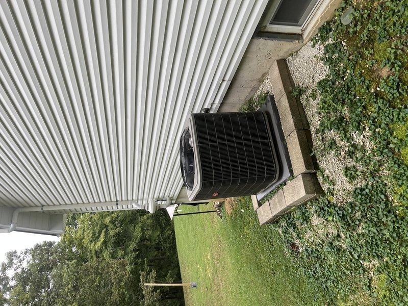 Completed comprehensive tune-up maintenance on single residential HVAC system including outdoor condensing unit and indoor furnace located in basement. Performed standard preventative maintenance procedures on black horizontal-discharge condenser unit positioned on concrete pad adjacent to building exterior, inspecting refrigerant levels, electrical connections, and fan motor operation. Accessed furnace system through attic space to inspect heat exchanger, burner assembly, and venting components, verifying proper combustion and airflow through ductwork and PVC flue piping.