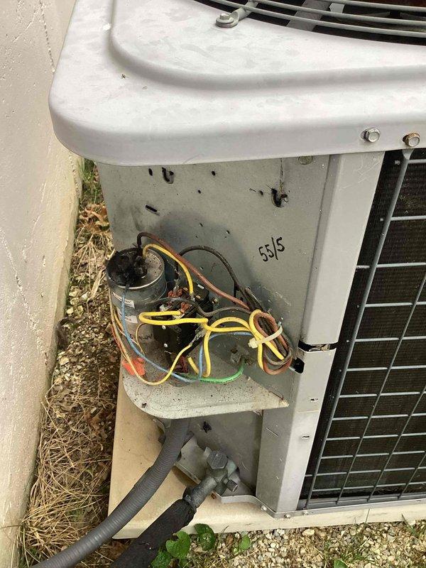 Responded to no cooling complaint on 10+ year old outdoor unit located on side of home. Upon arrival, found system had been shut off with only fan running. Accessed electrical compartment and inspected internal components including capacitor and wiring connections. Thermostat displayed 83 degrees, confirming lack of cooling performance. Documented unit condition with exterior debris present around base and evaluated system for necessary repairs to restore cooling operation.
