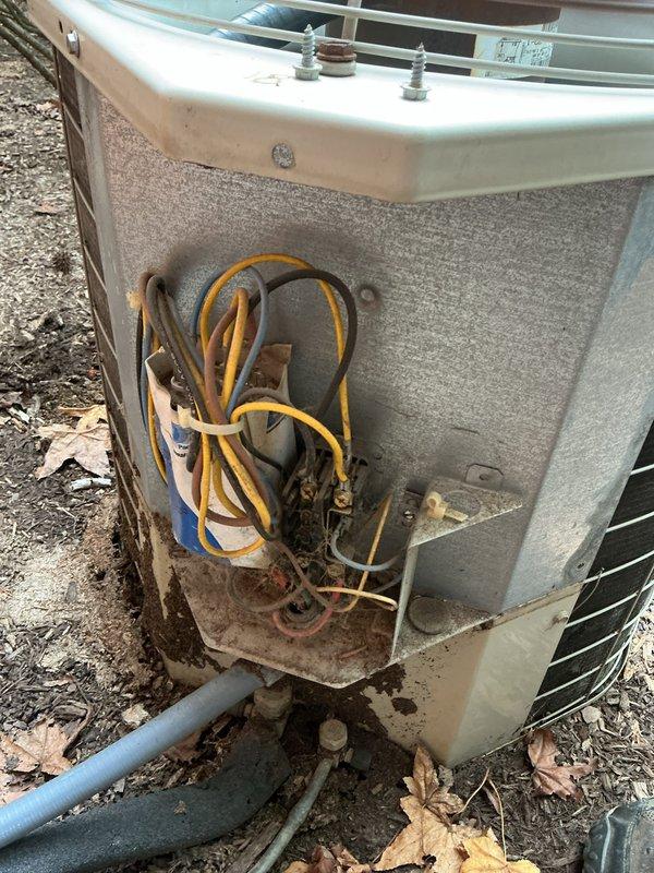 Responded to no cooling call on 10+ year old outdoor condenser unit located at side of home. Upon arrival, found unit not operating and producing no airflow. Performed diagnostic inspection revealing electrical component failure within condenser. Accessed electrical compartment and identified faulty contactor preventing compressor operation. Removed failed contactor, installed replacement component, and secured all electrical connections. Verified proper voltage at disconnect and breaker panel. Tested system operation, confirmed compressor engagement, proper refrigerant pressures, and adequate airflow from outdoor unit. System restored to normal cooling operation.