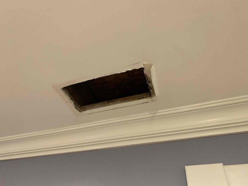 Responded to emergency call for AC leak causing water damage through ceiling from attic-mounted unit. Upon arrival, found active condensate leak from primary drain line on Unit 10, resulting in water intrusion and ceiling damage in room below. Shut down cooling operation per customer request while maintaining fan circulation to prevent additional moisture accumulation. Accessed attic unit and identified clogged condensate drain line as source of overflow. Documented water damage to ceiling including visible staining and compromised drywall requiring future repair. Cleared primary drain line obstruction and verified proper drainage flow. Tested secondary safety float switch operation and confirmed functional. Recommended monitoring system over next 24 hours and scheduling follow-up for ceiling repair once area fully dried.