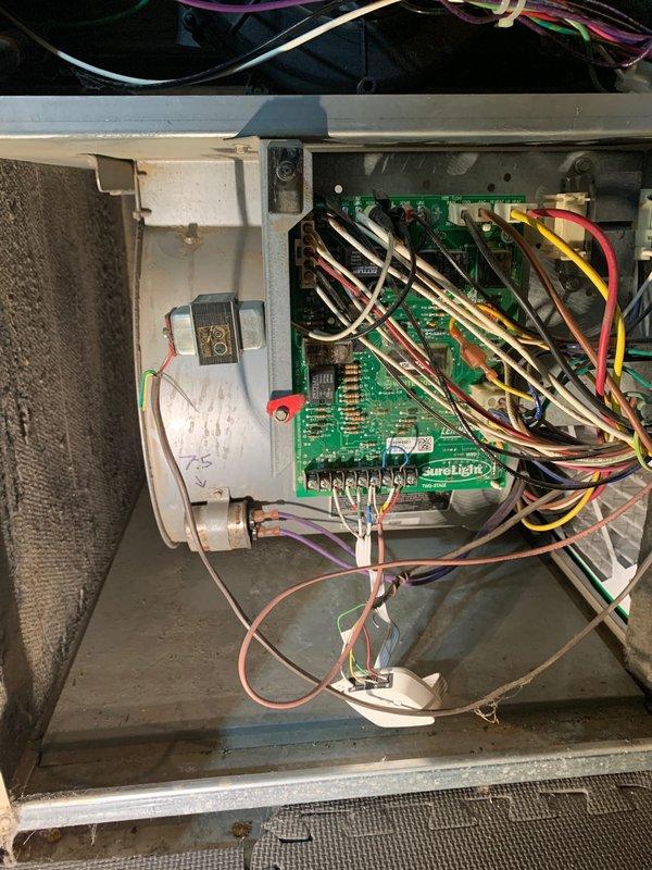 Performed comprehensive evaluation of dual-unit HVAC system serving three-story residence where inadequate cooling and airflow distribution issues were reported. Inspected both 10+ year-old units located on side of home, examined furnace control board with Surelight components and wiring connections, verified proper operation of electrical components including capacitor, assessed ductwork configuration in basement mechanical room, and evaluated 16x25x1 air filtration system. Provided customer with zone mapping to clarify which unit serves each floor and recommended adjustments to improve cooling efficiency and air distribution throughout all levels of the home.