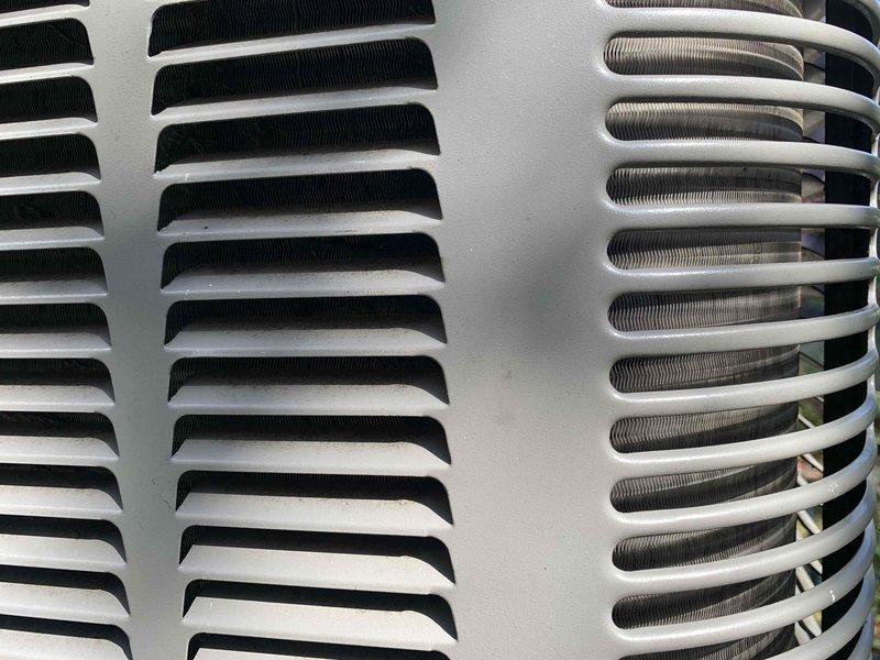 Completed comprehensive cooling season tune-up on 12-year-old Lennox air conditioning system with 13-year-old accessories. Performed full system inspection including blower wheel assembly cleaning and verification, checked all electrical connections, tested capacitors, measured refrigerant pressures, inspected condenser coil and fan operation, verified proper airflow through both intake louvers and discharge grille, and confirmed unit is operating within manufacturer specifications. System currently functioning normally with no immediate repairs required.
