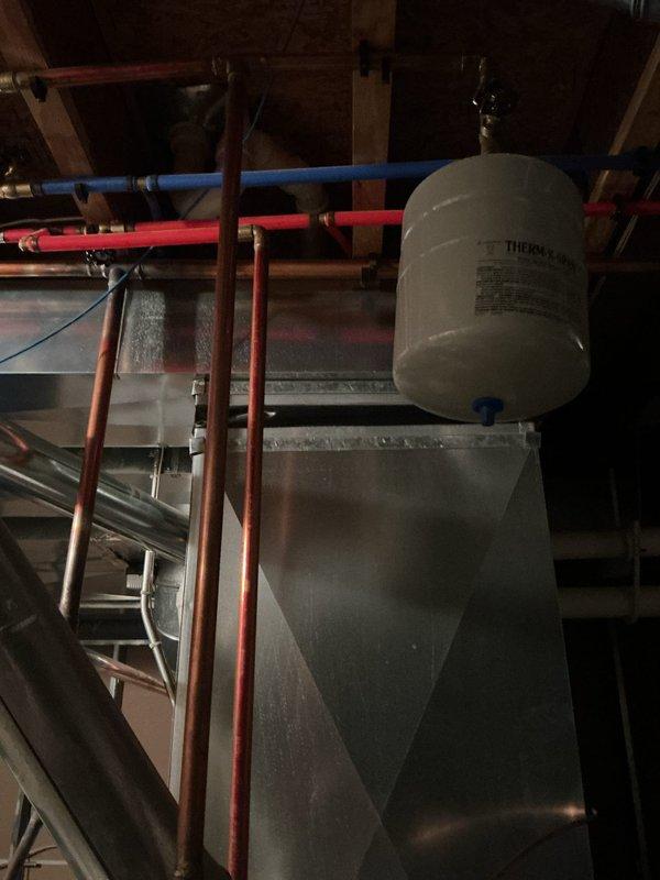 Responded to service call for insufficient hot water production in basement-located water heater. Upon inspection, determined existing unit was beyond economical repair. Removed and properly disposed of old water heater per local regulations. Installed new 50-gallon tall gas water heater with appropriate venting, gas line connections, and water supply lines. Connected hot and cold water distribution lines using PEX piping with proper support brackets. Installed expansion tank and pressure relief valve per code requirements. Completed all copper pipe connections and verified proper gas line installation. Applied for and obtained plumbing permit 26PLU-18721 with corresponding inspection sticker affixed to installation. Tested unit for proper ignition, combustion, and temperature output. Verified all connections for leaks and ensured adequate clearances around unit. System is now operational and producing hot water at appropriate temperatures.