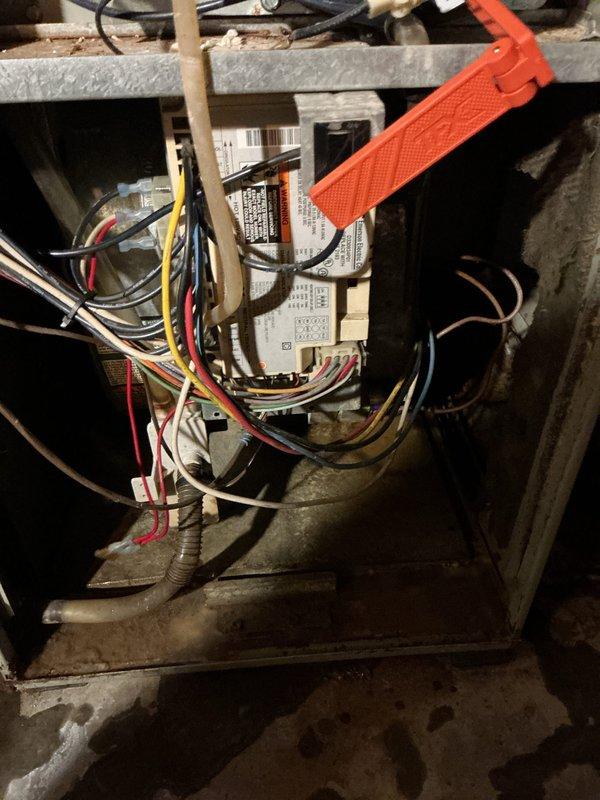 Completed comprehensive AC tune-up on 10-year-old residential air conditioning system. Performed standard maintenance protocol including inspection of outdoor condensing unit, electrical controls, and wiring connections. Identified active refrigerant leak in system requiring future attention. Inspected control board, relay module, and associated wiring harnesses for proper connections and functionality. Evaluated blower motor assembly and internal furnace components during indoor unit inspection. Noted moisture exposure evidence and corrosion on base pan and surrounding areas. System remains operational despite leak, with all electrical components functioning within normal parameters at time of service.