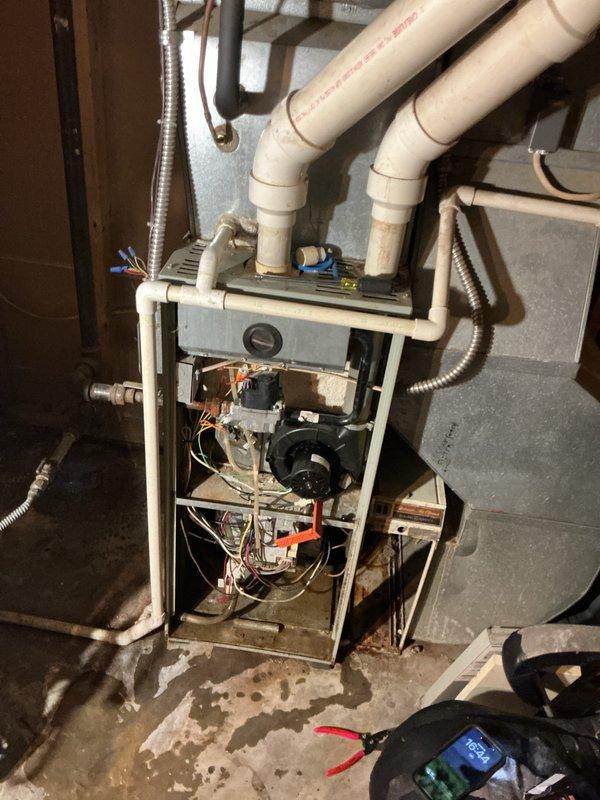 Completed comprehensive AC tune-up on 10-year-old residential air conditioning system. Performed standard maintenance protocol including inspection of outdoor condensing unit, electrical controls, and wiring connections. Identified active refrigerant leak in system requiring future attention. Inspected control board, relay module, and associated wiring harnesses for proper connections and functionality. Evaluated blower motor assembly and internal furnace components during indoor unit inspection. Noted moisture exposure evidence and corrosion on base pan and surrounding areas. System remains operational despite leak, with all electrical components functioning within normal parameters at time of service.