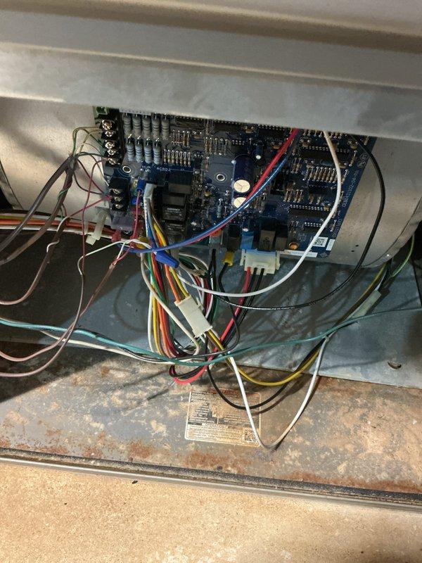 Completed comprehensive tune-up service on two 10-year-old air conditioning systems, one located in the basement and one in the attic. Performed standard maintenance procedures including inspection of control boards, electrical connections, and wiring configurations on both units. All circuit breakers, relay components, and terminal connections were examined and found operational, with photographic documentation captured of the electrical panels and control systems for service records.