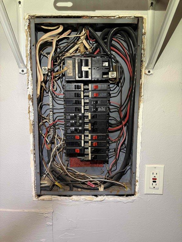 Performed comprehensive electrical safety inspection of residential property. Conducted thermal imaging scan of all accessible outlets and wall surfaces to identify potential hotspots or abnormal heat signatures—no elevated temperatures detected. Inspected main electrical panel and documented existing conditions: noted moderate corrosion and rust on panel frame edges where metal meets wall surface, indicating possible moisture exposure over time. Verified all circuit breakers for proper seating and operation; all breakers functional with no signs of overheating or damage. Evaluated wire management within panel box—connections secure though wire bundling shows typical age-related congestion. Tested smoke detector for proper operation and battery condition. Inspected visible outlets throughout property for secure mounting, proper grounding, and signs of arcing or heat damage—all outlets tested within normal parameters. Overall electrical system operating safely with no immediate hazards 