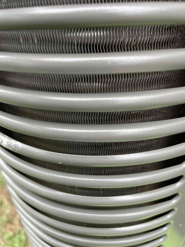 Responded to no cooling complaint on 2-year-old Lennox unit affecting entire home. Upon arrival, confirmed system running but not producing cold air. Performed visual inspection of evaporator coil assembly, documenting condition with photos. Coil showed evidence of restricted airflow with dust and debris accumulation visible on fins and beneath coil assembly. The heat exchanger fins displayed characteristic zigzag pattern with particulate buildup between slats, reducing heat transfer efficiency. Updated customer contact information in system for future service coordination. Unit requires thorough coil cleaning and airflow restoration to resolve cooling deficiency.