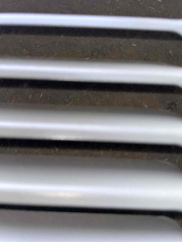 Responded to no cooling complaint on 2-year-old Lennox unit affecting entire home. Upon arrival, confirmed system running but not producing cold air. Performed visual inspection of evaporator coil assembly, documenting condition with photos. Coil showed evidence of restricted airflow with dust and debris accumulation visible on fins and beneath coil assembly. The heat exchanger fins displayed characteristic zigzag pattern with particulate buildup between slats, reducing heat transfer efficiency. Updated customer contact information in system for future service coordination. Unit requires thorough coil cleaning and airflow restoration to resolve cooling deficiency.