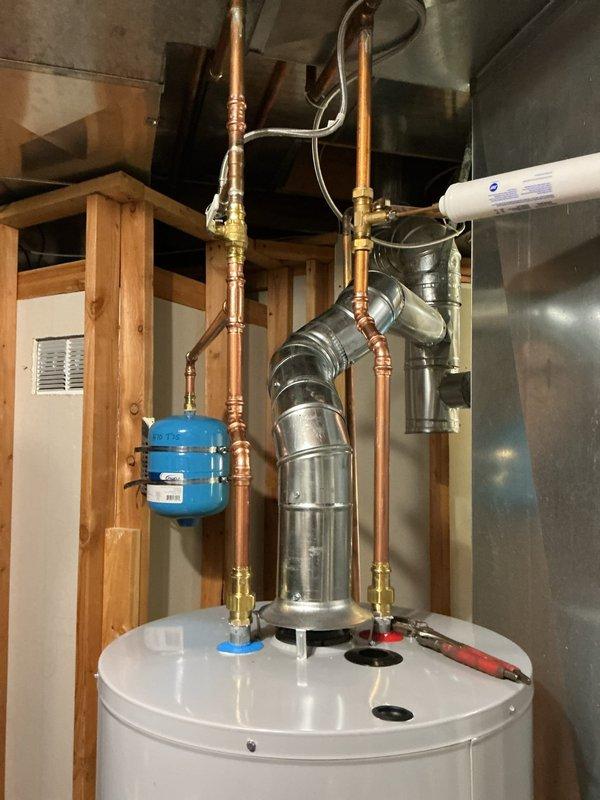 Installed a 50-gallon gas tall water heater with proper copper supply line connections, brass fittings, and metallic vent flue system in accordance with code requirements. Installation included integration with existing expansion tank and pressure regulation components, with permit obtained through City of Ballwin (Permit #26-004631). All connections were secured, tested for proper operation, and system was verified functional upon completion.