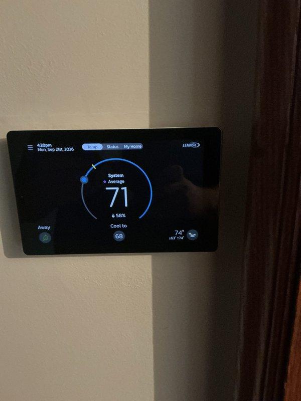 Responded to no cooling complaint on recently installed Lennox system approximately 3-4 months old. Upon arrival, verified thermostat displayed 71°F system average with setpoint at 68°F, indicating unit was not maintaining desired temperature. Inspected indoor air handler unit, confirmed proper installation with refrigerant lines, insulation, and condensate drainage intact. Took diagnostic photos of thermostat display and internal unit components for documentation. System evaluated and adjustments made to restore proper cooling operation to whole house.