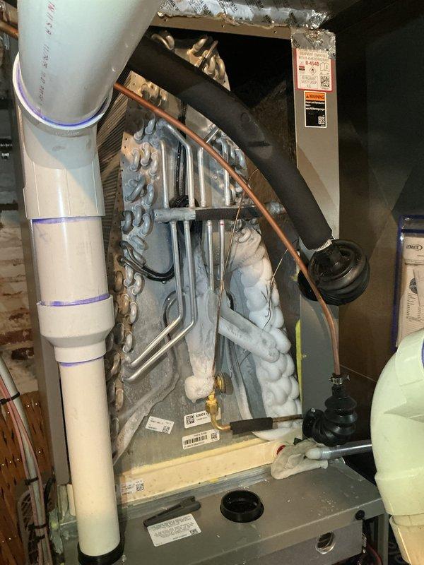 Responded to no cooling complaint on recently installed Lennox system approximately 3-4 months old. Upon arrival, verified thermostat displayed 71°F system average with setpoint at 68°F, indicating unit was not maintaining desired temperature. Inspected indoor air handler unit, confirmed proper installation with refrigerant lines, insulation, and condensate drainage intact. Took diagnostic photos of thermostat display and internal unit components for documentation. System evaluated and adjustments made to restore proper cooling operation to whole house.