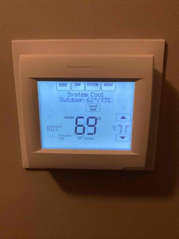 Completed comprehensive Supertune service on basement HVAC system unit U10 with ground-level condenser. Performed full system inspection of blower motor assembly, verified proper operation of all mechanical components, and checked gas valve actuator connections. Inspected Honeywell programmable thermostat displaying proper system operation in cooling mode with indoor temperature at 69°F and outdoor conditions at 62°F. Confirmed all safety labels present and legible, verified blower housing ventilation and airflow, and ensured all electrical connections secure. System operating within normal parameters with no deficiencies noted.