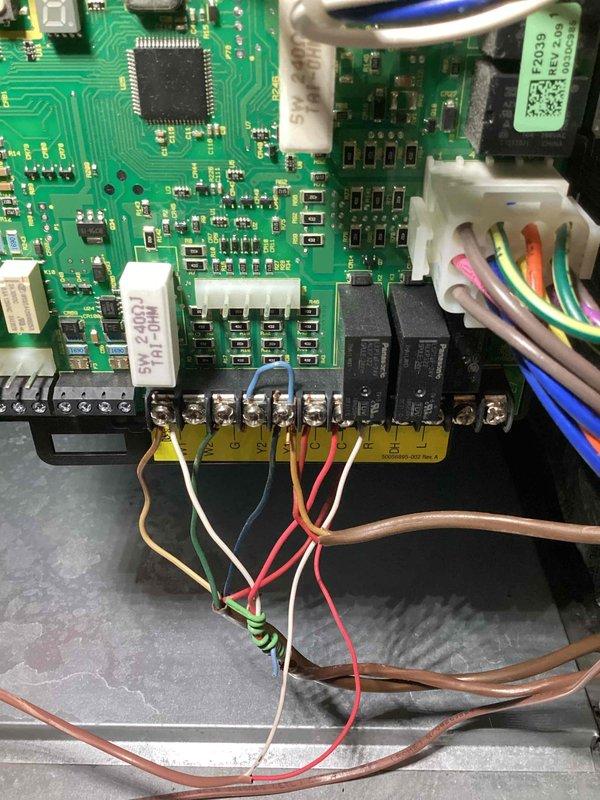 Replaced defective ECM motor control board under warranty to restore cooling operation to HVAC system. Removed failed control board (S/N 5921D06018) and installed new replacement unit, reconnecting all wire harnesses and terminal connections to terminal block. Verified proper electrical connections, tested system operation, and retained original defective part per warranty requirements.