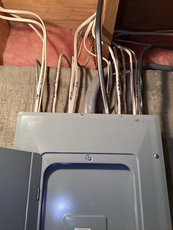 Conducted on-site electrical estimate for new outlet installation. Assessed existing electrical infrastructure, including main breaker panel and associated wiring in attic space. Documented current panel configuration, wire routing, and insulation clearances to determine optimal circuit path and materials required for proposed outlet addition. Photographed electrical panel conditions and surrounding work area for estimate preparation.