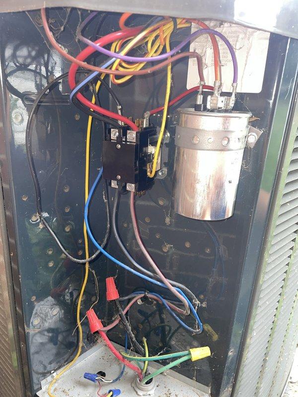 Responded to no cooling complaint with ice formation on unit U10 located at back of home. Upon arrival, instructed occupant to turn off AC unit while leaving fan in ON position to allow ice to thaw. Inspected electrical control panel and contactor assembly, documenting existing wiring connections and component conditions. Observed aged HVAC system with visible wear on electrical enclosure and components, including oxidation on terminal connections. Capacitor and contactor assembly inspected and photographed for service records. System shows signs of extended service life with weathered components throughout electrical compartment.