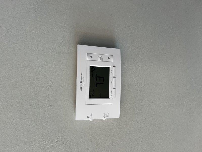 Replaced two existing thermostats with new White-Rodgers programmable units on both HVAC systems. Installed clean white thermostats, verified proper wiring connections, configured temperature settings, and confirmed both units were operating correctly with systems responding to temperature calls.