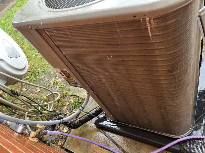 Completed cooling system tune-up on residential AC unit located at side of home. Performed standard maintenance inspection, checked refrigerant levels registering 13.5 degrees superheat, and evaluated overall system operation. Unit exterior shows weathering and discoloration but all mechanical components functioning properly.