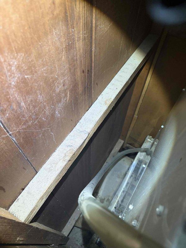 Responded to no-cool complaint on 7-year-old Trane system with secondary issue of condensate drain overflow causing water damage in hallway. Upon inspection in attic space, found primary condensate drain line completely blocked, preventing proper drainage and causing water to back up into secondary overflow pan. Cleared blockage from drain line using appropriate methods and verified proper flow and drainage. Inspected evaporator coil and drain pan for debris accumulation and signs of microbial growth. Tested system operation following drain clearing to confirm proper cooling function and condensate removal. Verified all electrical connections secure on air handler and confirmed proper airflow through system. System restored to normal operation with adequate drainage and cooling capacity confirmed.