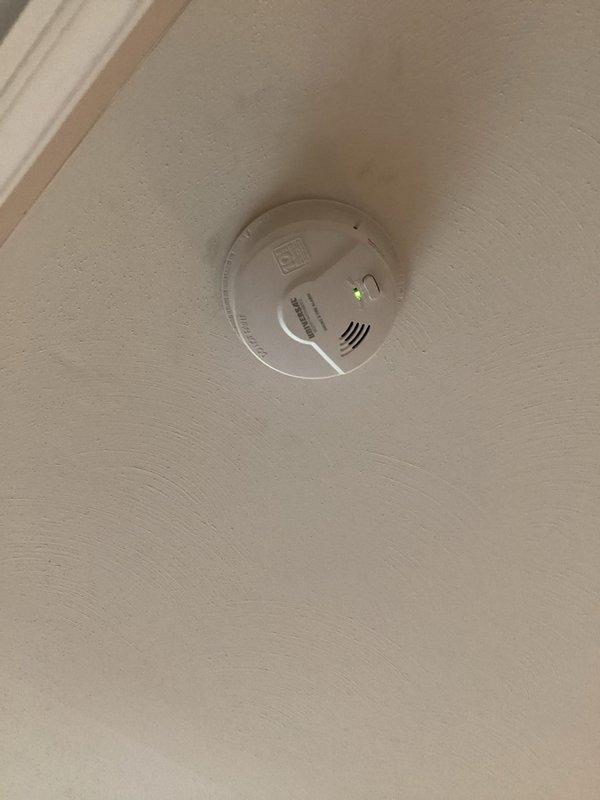Installed six customer-supplied smoke detectors throughout the residence, mounting units to ceiling surfaces and ensuring proper power connections with operational LED indicators confirmed on all devices. All detectors were tested and verified functioning correctly upon completion of installation.
