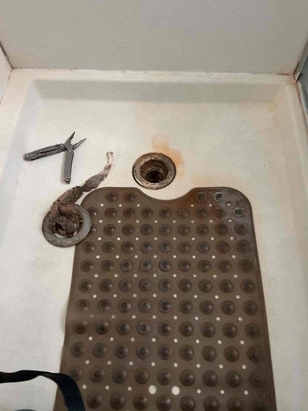 Responded to emergency call for wedding ring retrieval from shower drain. Upon arrival, removed existing drain cover and inspected drain assembly. Successfully retrieved wedding ring using specialized retrieval tools and confirmed no damage to item. Reinstalled drain cover and tested drain flow to ensure proper operation. No additional plumbing issues identified during service visit.