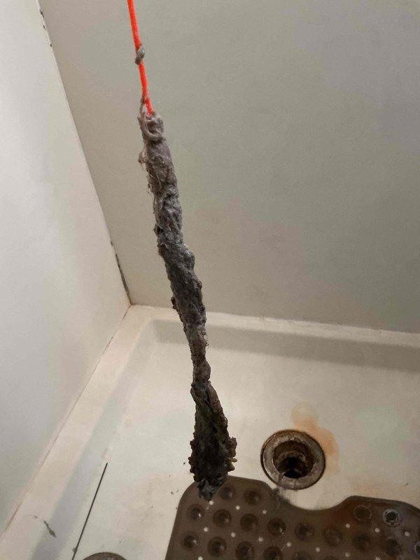 Responded to emergency call for wedding ring retrieval from shower drain. Upon arrival, removed existing drain cover and inspected drain assembly. Successfully retrieved wedding ring using specialized retrieval tools and confirmed no damage to item. Reinstalled drain cover and tested drain flow to ensure proper operation. No additional plumbing issues identified during service visit.