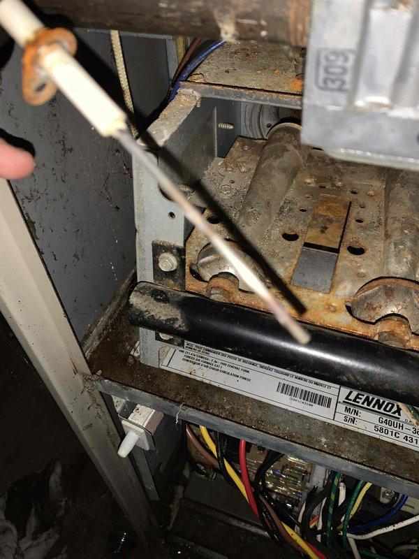 # O10 Furnace Tune-Up - Basement Installation

Completed comprehensive tune-up service on a 10-year-old Lennox furnace located in basement. Upon inspection, unit exhibited significant dust accumulation, surface oxidation on metal components, and general wear consistent with age. Accessed interior compartment to inspect electrical connections, capacitor, and control wiring. All wire connections were verified secure with red, yellow, black, and blue wiring intact to respective terminals. 

Inspected capacitor and electrical components for proper operation. Noted heavy dust buildup throughout cabinet interior and on heat exchanger surfaces. Cleaned accessible areas to improve airflow efficiency and reduce potential fire hazards from debris accumulation. Examined ductwork connections showing standard wear and minor surface rust on galvanized metal transitions.

Verified blower motor operation and checked amp draw within manufacturer specifications. Inspected gas valve assembly and confirme