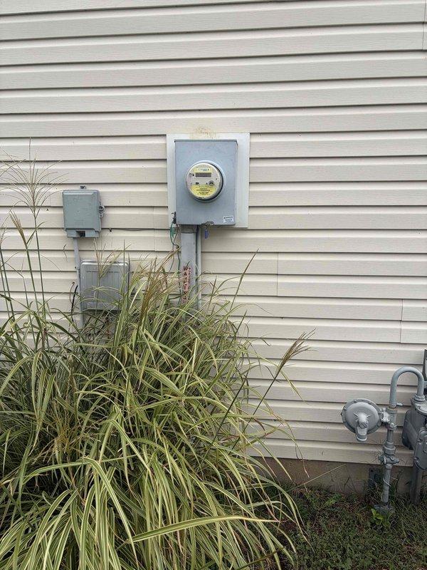 Responded to service call for circuit breaker that would not remain in the on position for two-bedroom circuit. Upon arrival, conducted visual inspection of exterior electrical service equipment including meter enclosure and main panel accessibility. Verified power supply integrity at meter base and confirmed proper utility connection. Documented existing electrical infrastructure with digital photographs showing Ameren Gridstream RF digital meter installation, service entrance equipment, and exterior panel configuration mounted on residential vinyl siding. Based on symptom description of breaker failing to lock in position, issue indicates internal breaker mechanism failure requiring breaker replacement to restore reliable power to affected bedroom circuits.