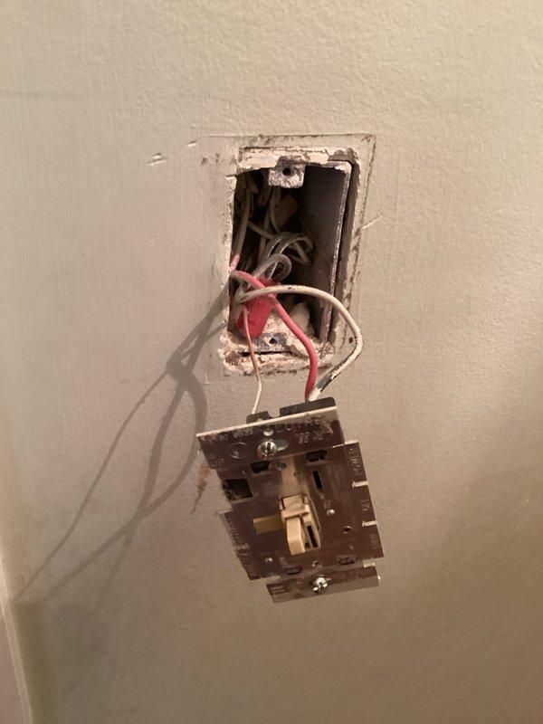 Responded to service call for non-functioning ceiling fan and electrical issues including flickering lights and hot outlets in multiple rooms. Performed comprehensive electrical inspection and troubleshooting of affected circuits in bedroom, dining room, and kitchen areas. Identified and addressed defective switch mechanisms and compromised wiring connections at multiple locations, removed faulty devices from electrical boxes, and documented existing conditions showing deteriorated wire terminations and improper installations contributing to intermittent power issues and overheating concerns.