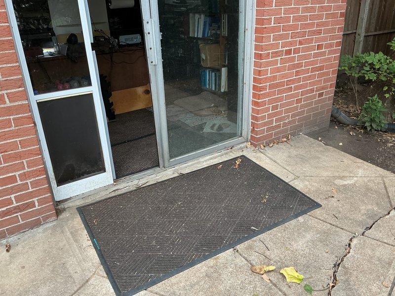 Responded to main floor drain backup in basement. Upon arrival, found extensive sewage water damage in basement corner with significant black water contamination spread across floor area. Accessed cleanout location in backyard through exterior sliding door entrance. Performed time and materials cleanout service on main sewer line to clear obstruction causing basement drain backup. Successfully restored proper drainage flow through ground water drain system. Backup was resolved and system returned to normal operation.