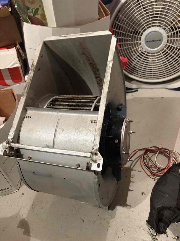 Responded to no heat call at single-family residence with 12-year-old furnace located in basement. Upon inspection, diagnosed failed blower motor preventing air circulation through system. Removed and replaced defective blower motor assembly, which showed significant dust accumulation and wear consistent with age of unit. Cleaned blower wheel and housing during replacement process. Tested system operation, verified proper airflow and heating functionality. Unit restored to full operational status.